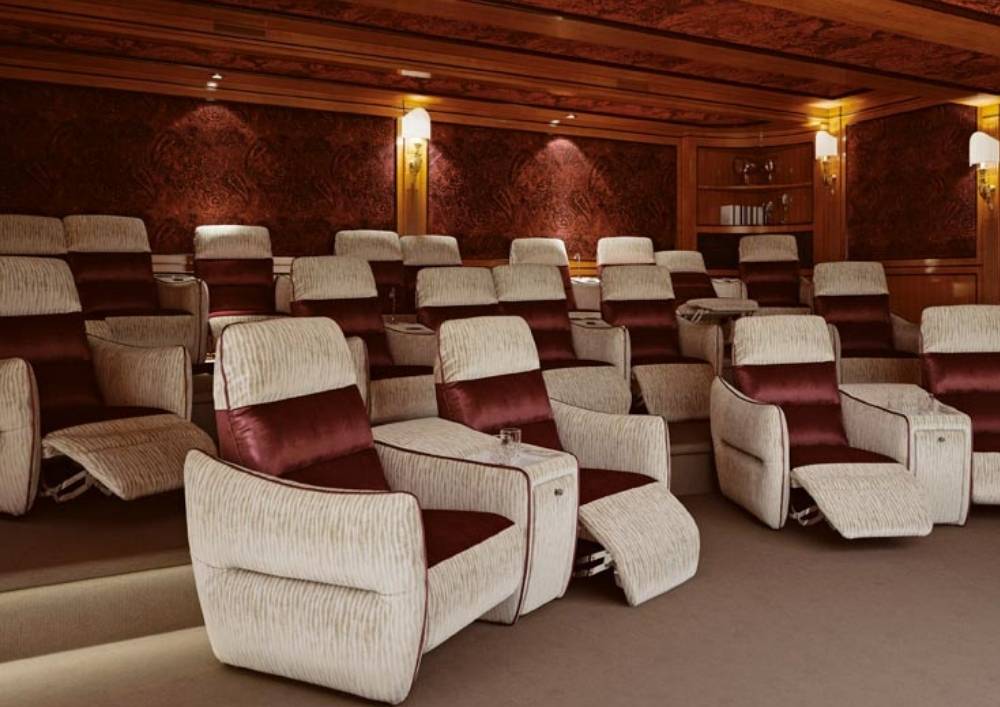 Custom home cinema installation in Dubai with tiered seating and acoustic wall panels